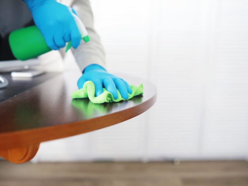 cleaning a table white a water spray